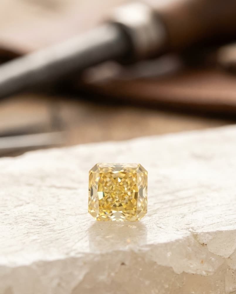 Macro study of a natural fancy-yellow diamond — editorial imagery of the colour family we source